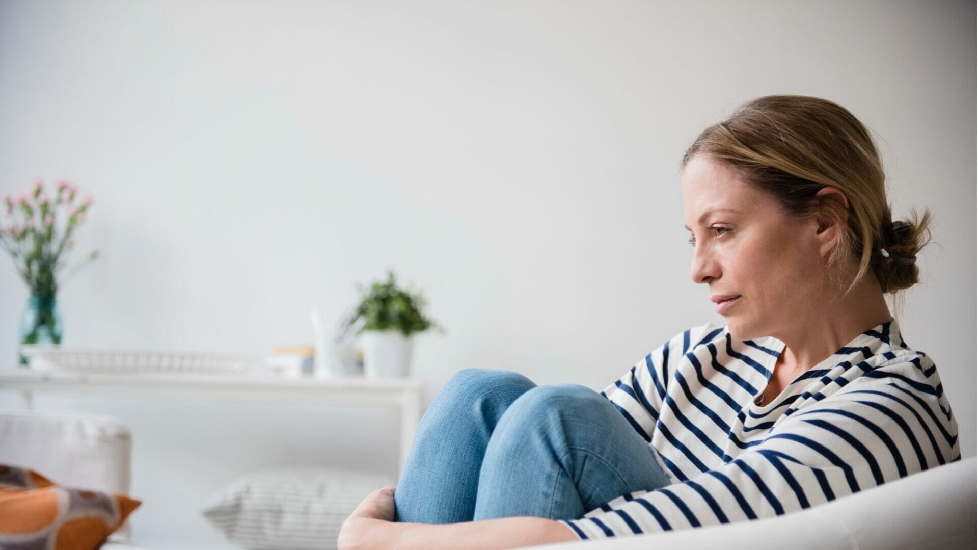 loneliness. woman sitting alone on a couch