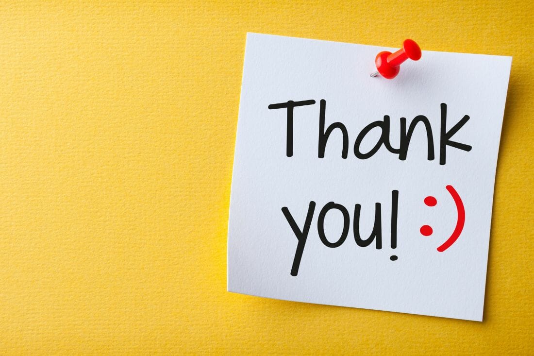 thank you sign on a yellow background with a red smileyface emoticon