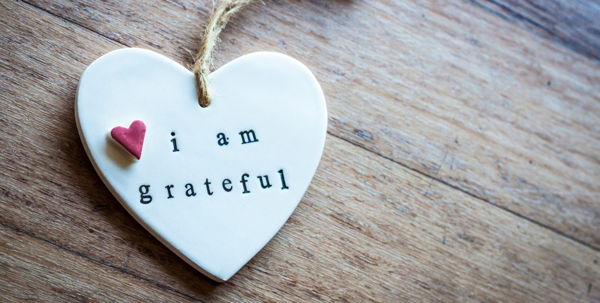 a heart shaped ornament with the words I am grateful written on it
