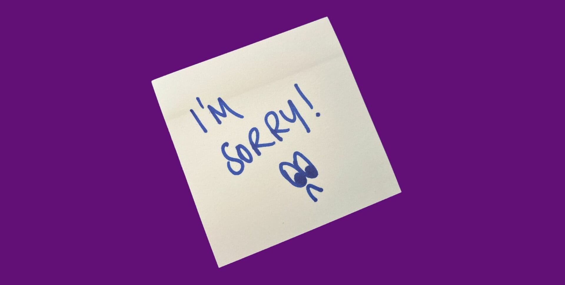 image of a yellow square postit note on a purple background. On the postit note is written 'I'm sorry!' with a sad face