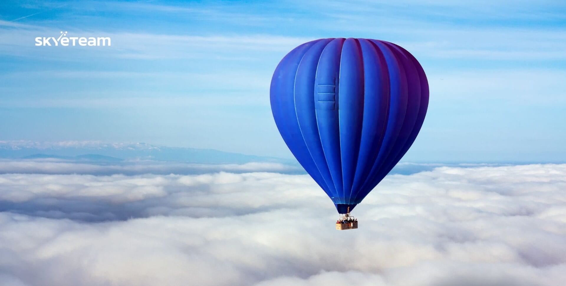 a blue hot air balloon above the clouds a metaphor for workplace loneliness and workplace relationships