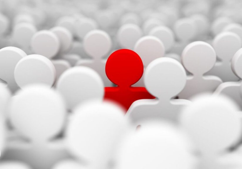 a graphic of one red human shaped icon amongst a group of pale icons - connection at work