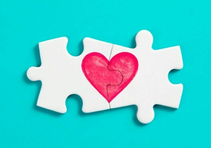 meaningful connection metaphor two jigsaw pieces connected to make a heart on a blue background